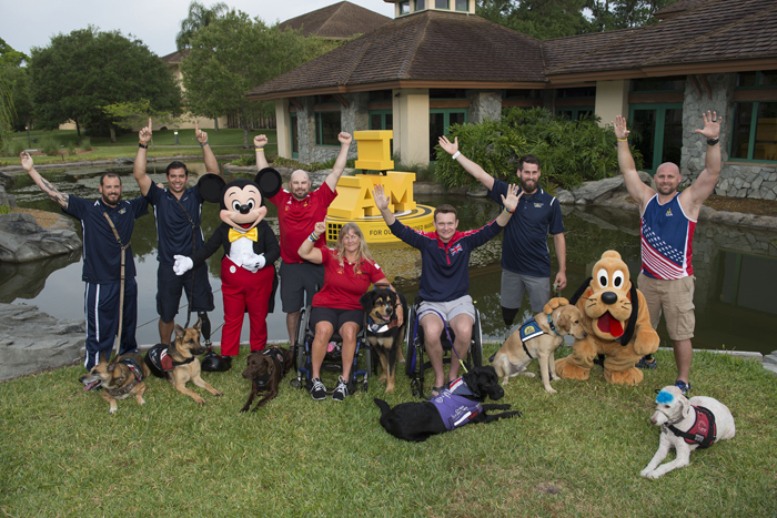 Ahead of the Invictus Games Orlando 2016 closing ceremony, Mickey Mouse and Pluto celebrate service dogs and competitors, (L-R) Leonard Anderson with Azza, August ONiell with Kai (USA), Luc Martin with Trail, Christine Gauthier with Battak (Canada), Jon Flint with Jester (Great Britain), Stefan LeRoy with Knoxville and Brett Parks with Freedom (USA)