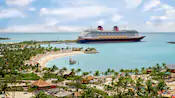 A Disney Cruise Line ship docked at a beach in Castaway Cay