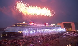 Disney Dream Floats Out - As pyrotechnics light the sky, the Disney Dream cruise ship makes its first public appearance Oct. 30, 2010 in Papenburg, Germany as it exits an enclosed building dock, pulled by a tugboat, at the Meyer Werft shipyard. Thousands of local residents gathered to see the "float out" ceremony. The new ship is scheduled to sail its maiden voyage Jan. 26, 2011 from Port Canaveral, Fla