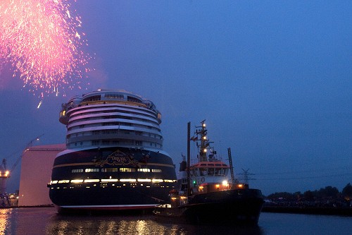 OCTOBER 30, 2010): As pyrotechnics light the sky, the Disney Dream cruise ship makes its first public appearance Oct. 30, 2010 in Papenburg, Germany as it floats out of an enclosed building dock, pulled by a tugboat, at the Meyer Werft shipyard. Thousands of local residents gathered to see the "float out" ceremony. The new ship is scheduled to sail its maiden voyage Jan. 26, 2011 from Port Canaveral, Fla. (Diana Zalucky, photographer) 